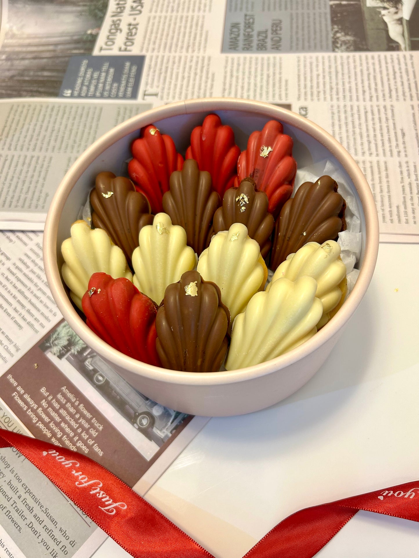Madeleines in round box with ribbon
on the background