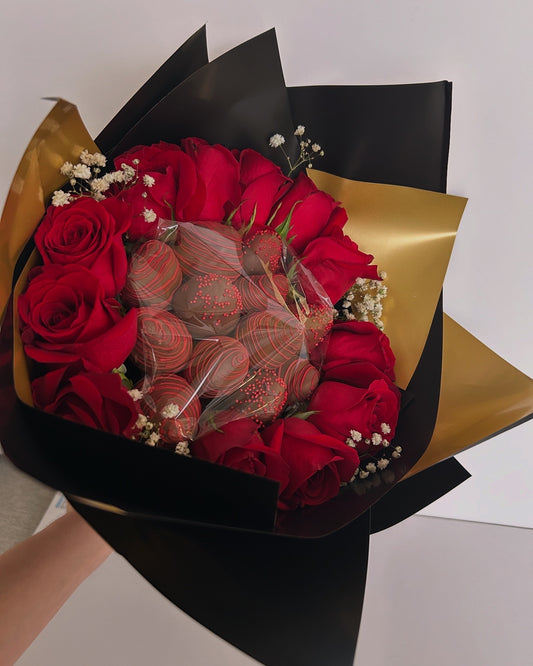 Bouquet of chocolate covered strawberries and roses with black and gold wrapping 