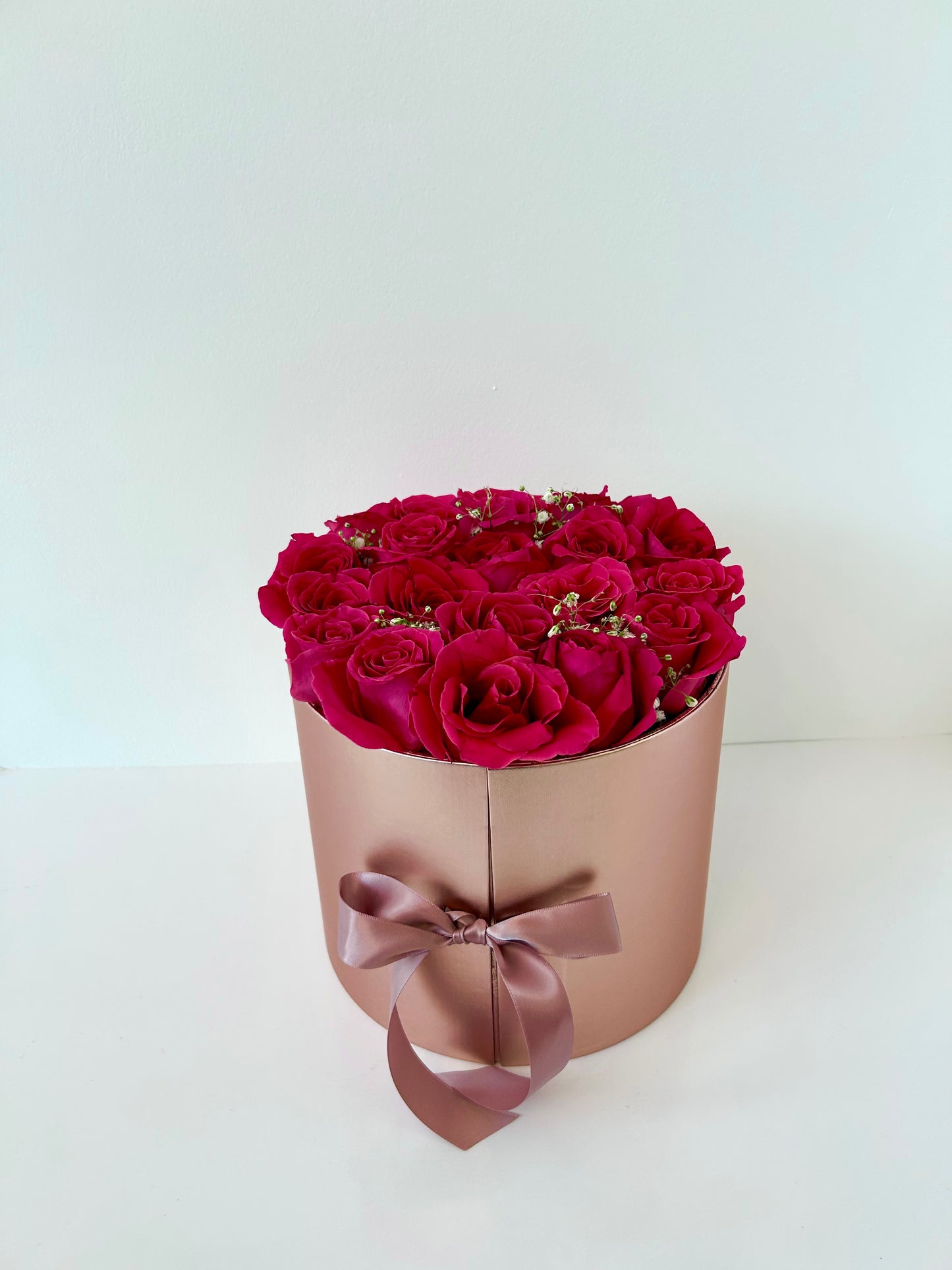 Pink flower box with pink roses on a white background