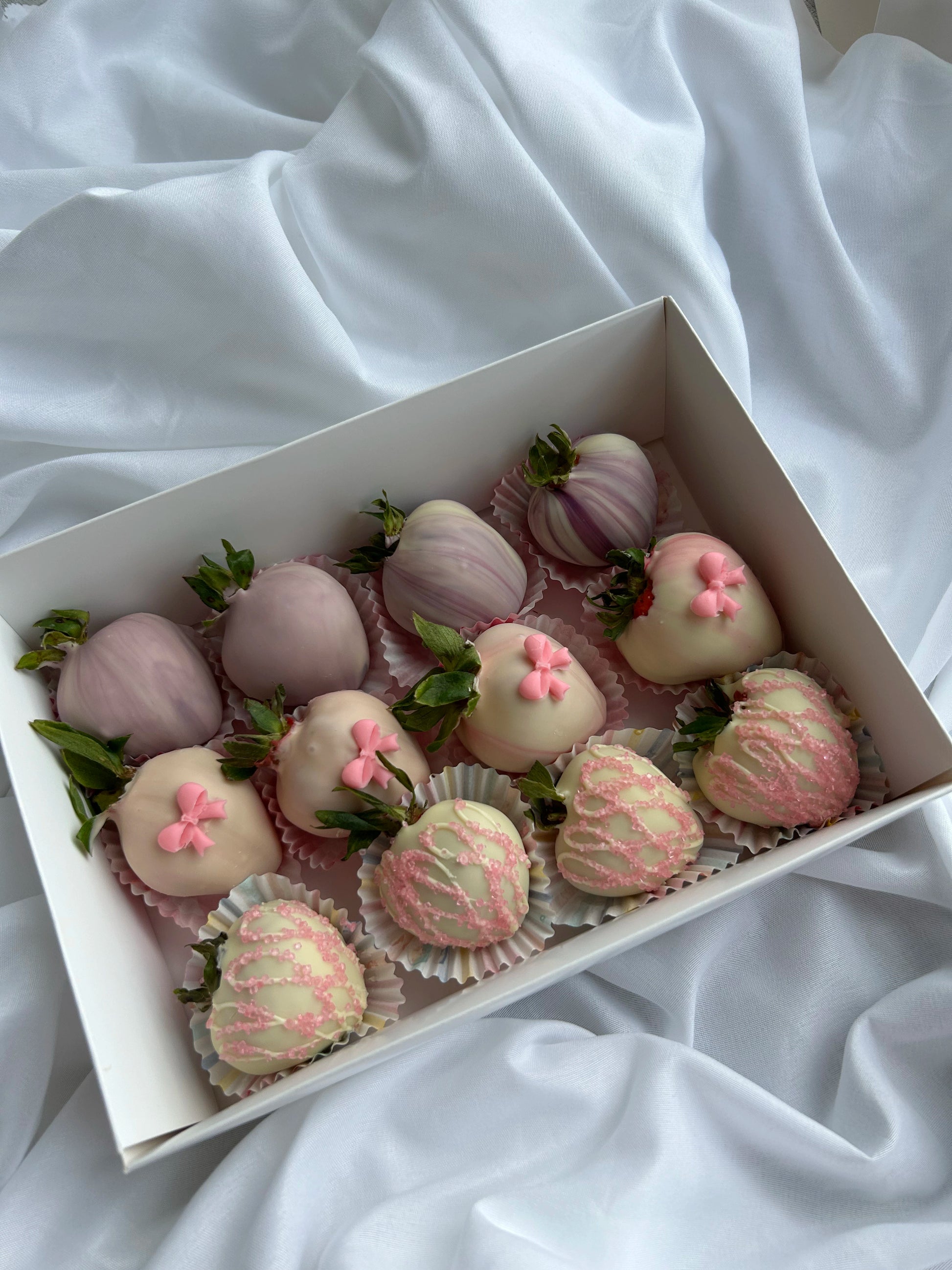 chocolate dipped strawberries in white box on the white background