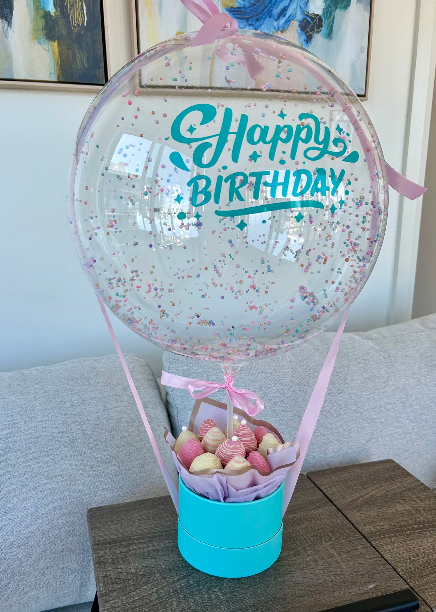 Happy Birthday sticker on bobo balloon with chocolate covered strawberries in the box 