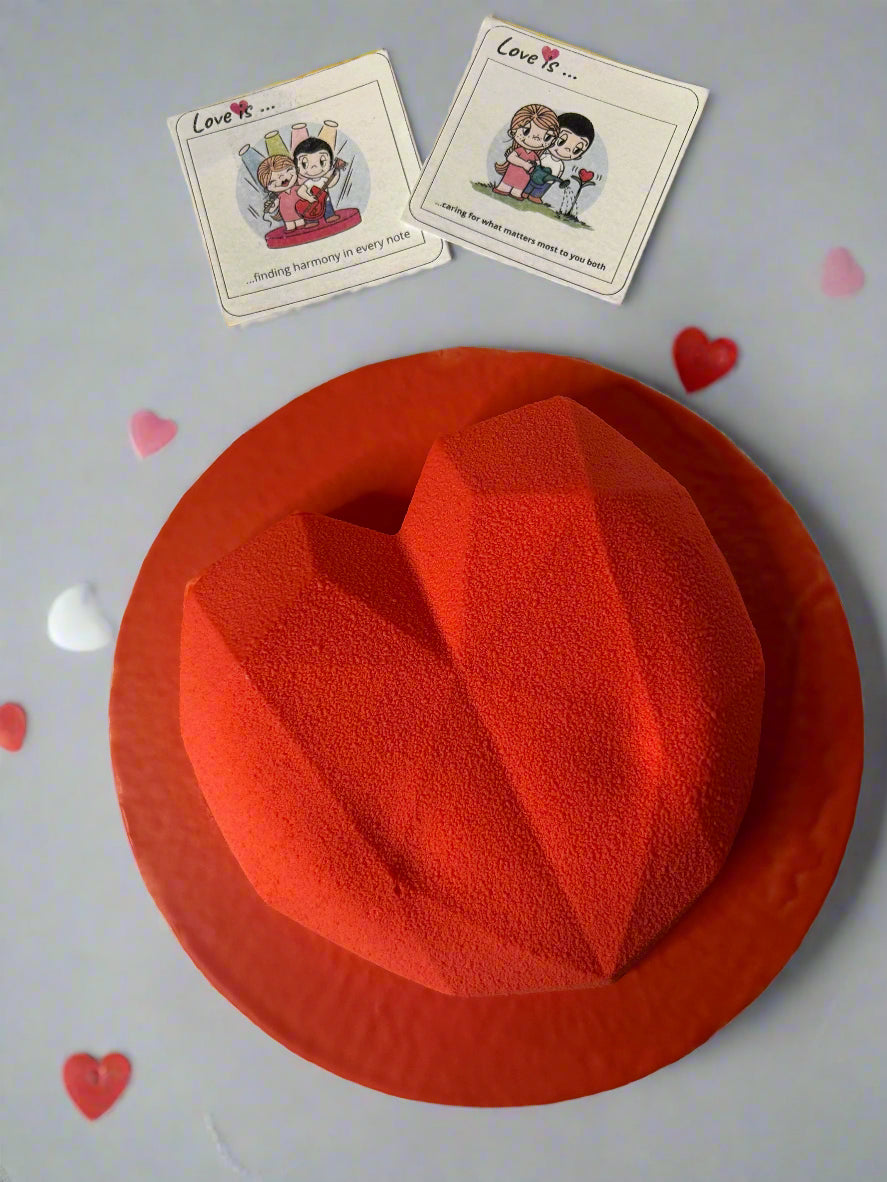 red heart shaped Mousse cake on grey background with cards