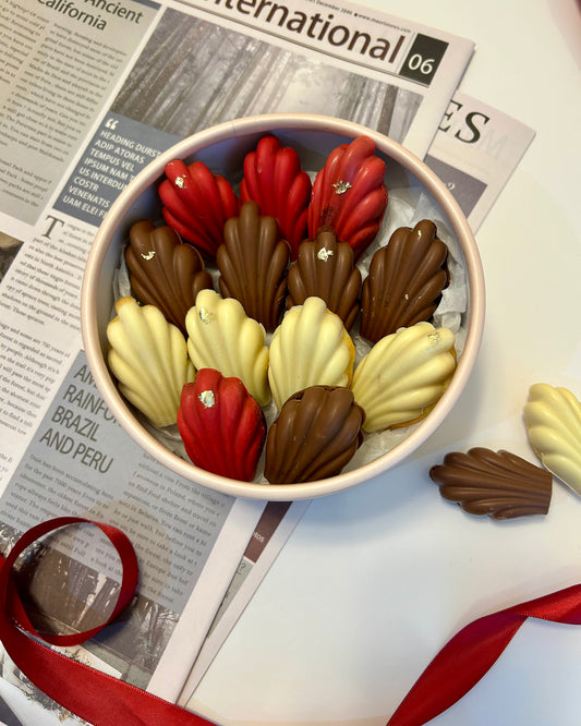 Madeleines in round box with ribbon 
