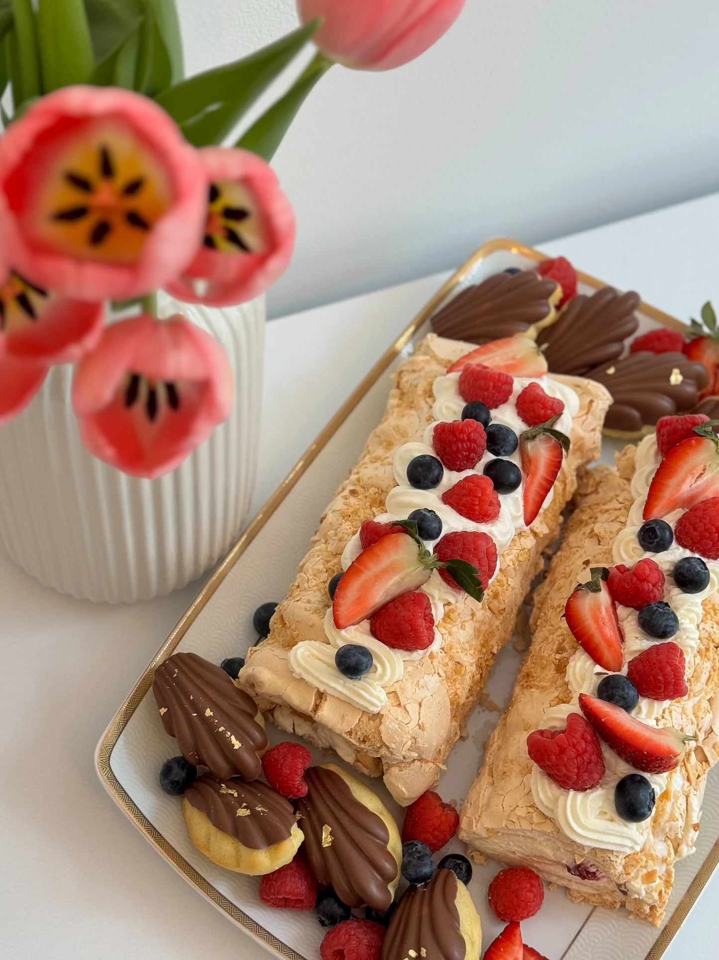 Airy and light meringue dessert with strawberries, blueberries, and raspberries