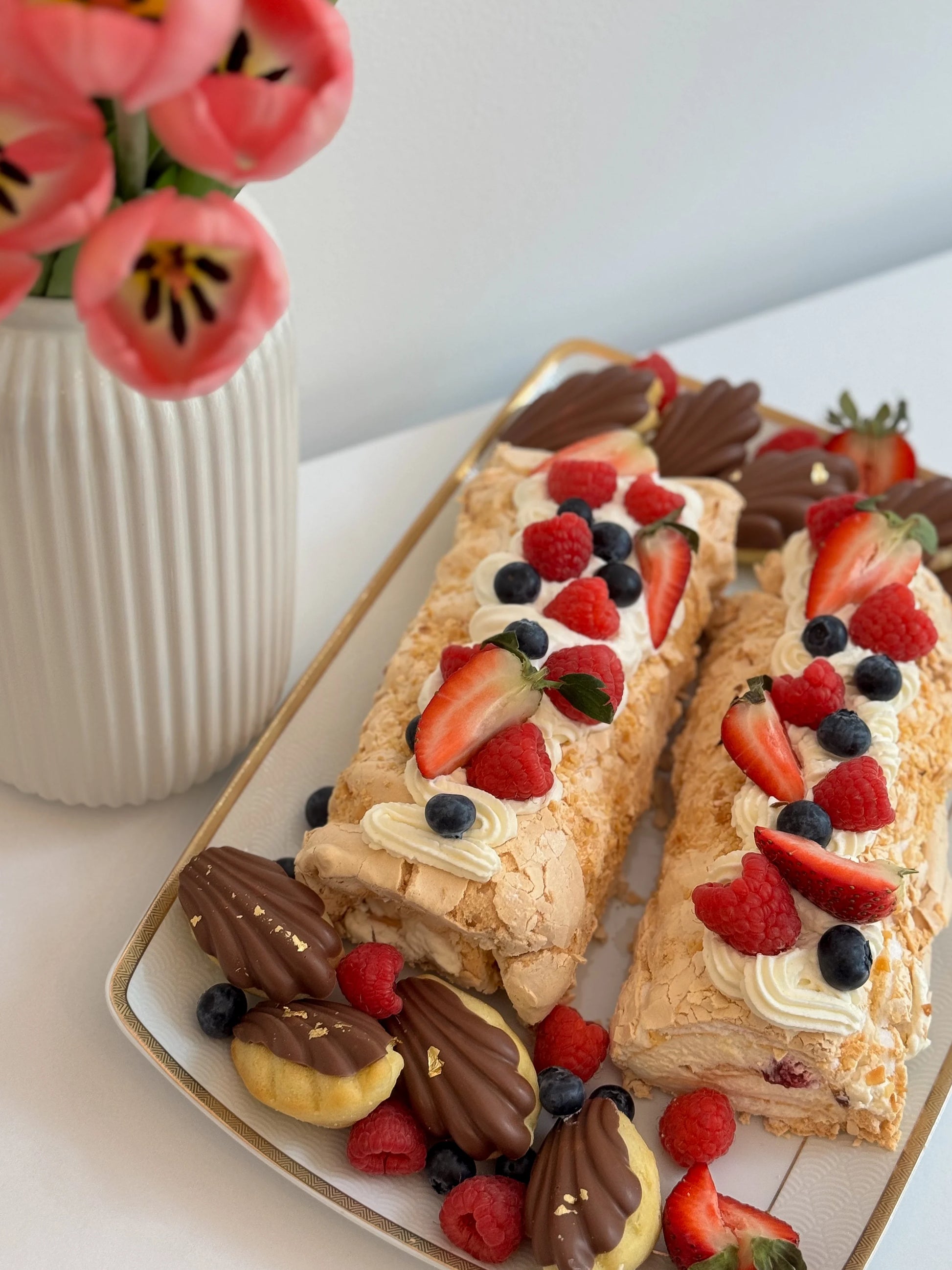 Close-up of meringue roulade texture with whipped cream and berry filling
